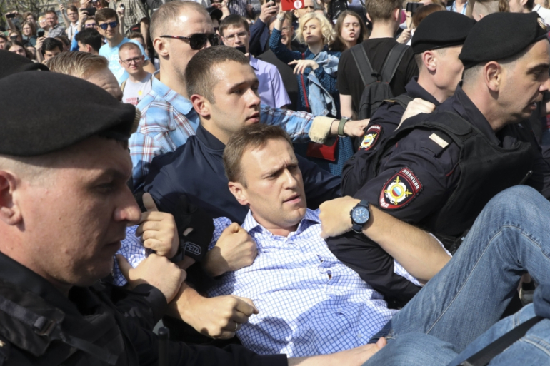 Alexei Navalny taken away by police during one of his numerous protests